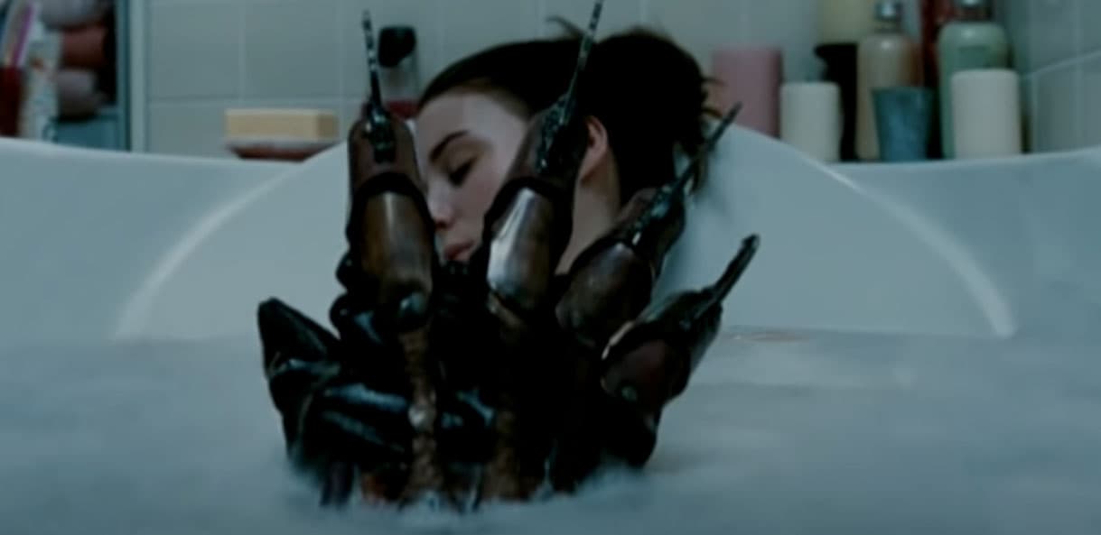 Freddy Krueger's glove breaching the water of a bath tub